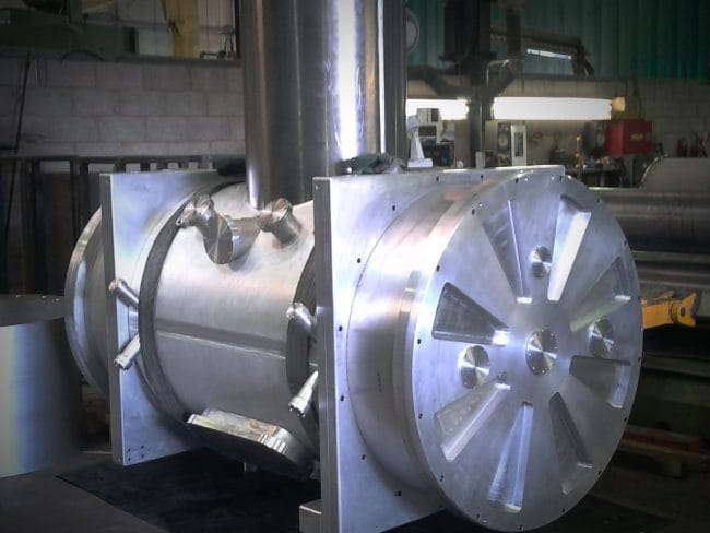 Large stainless steel fabricated vessel with machined end plate in workshop